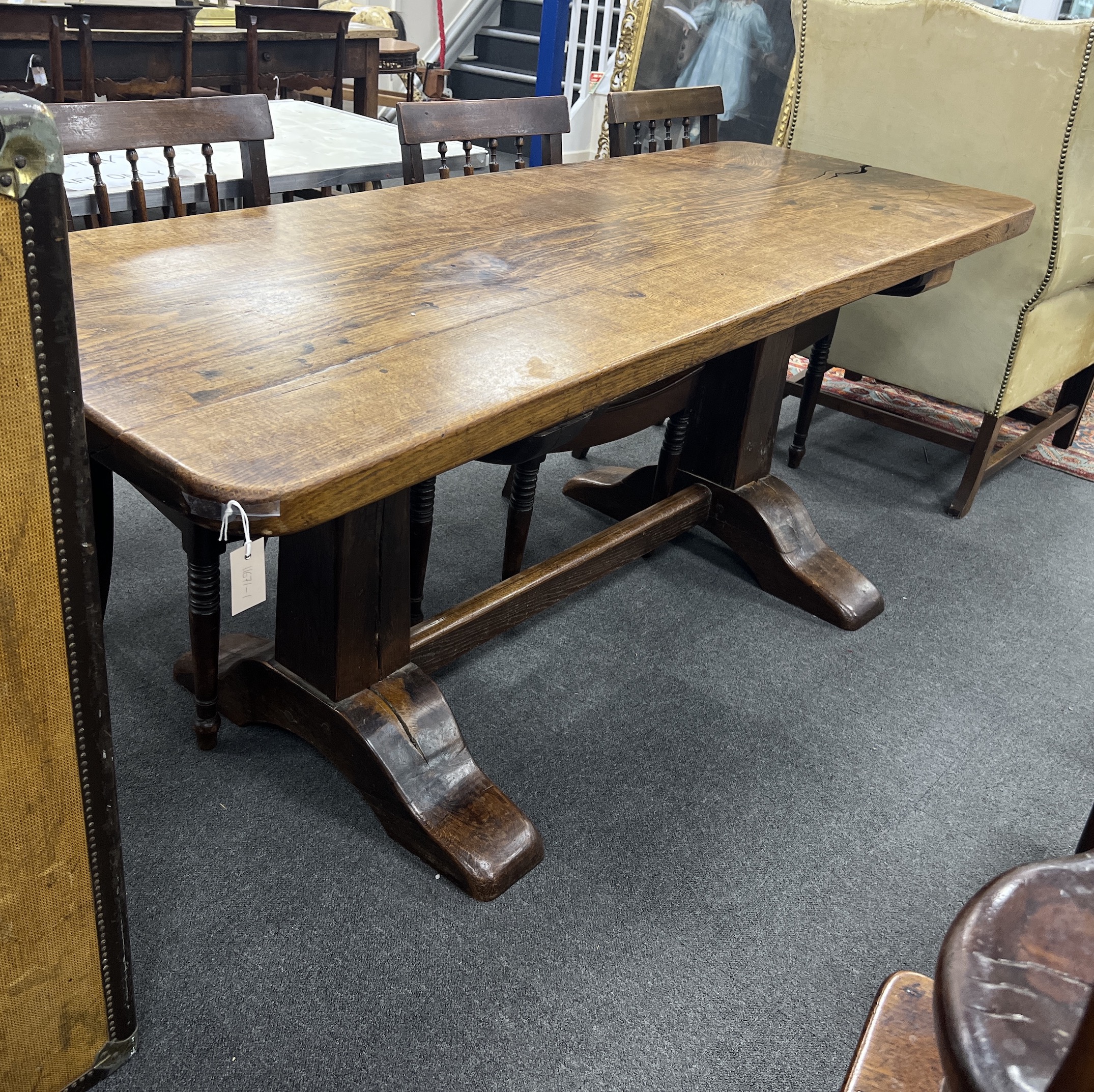 An 18th century style rectangular oak refectory table with single plank top on square end standards, length 194cm, depth 74cm, height 78cm